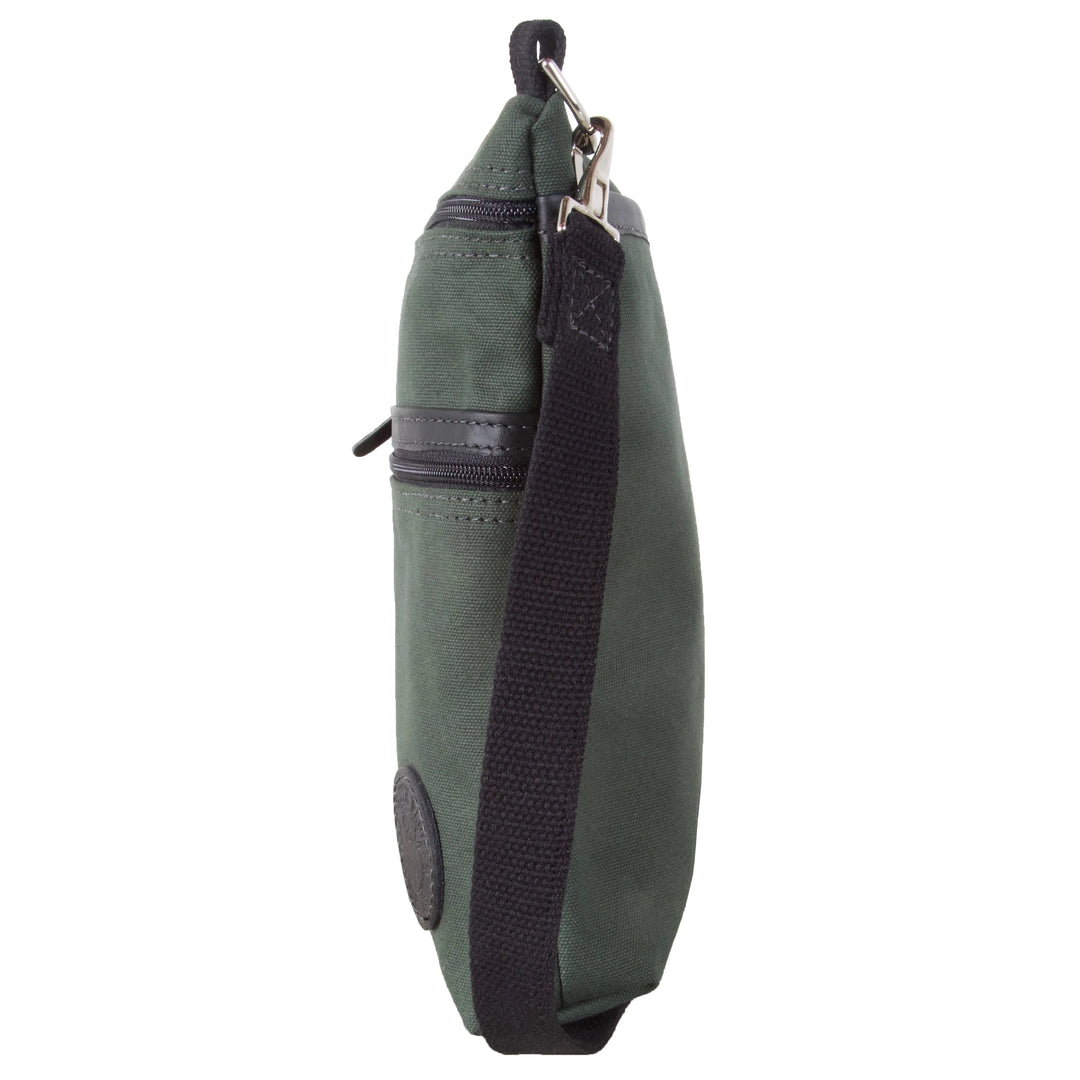 Traverse Crossbody Bag in olive drab canvas with black adjustable strap, designed by Duluth Pack for durable outdoor use and everyday carry.