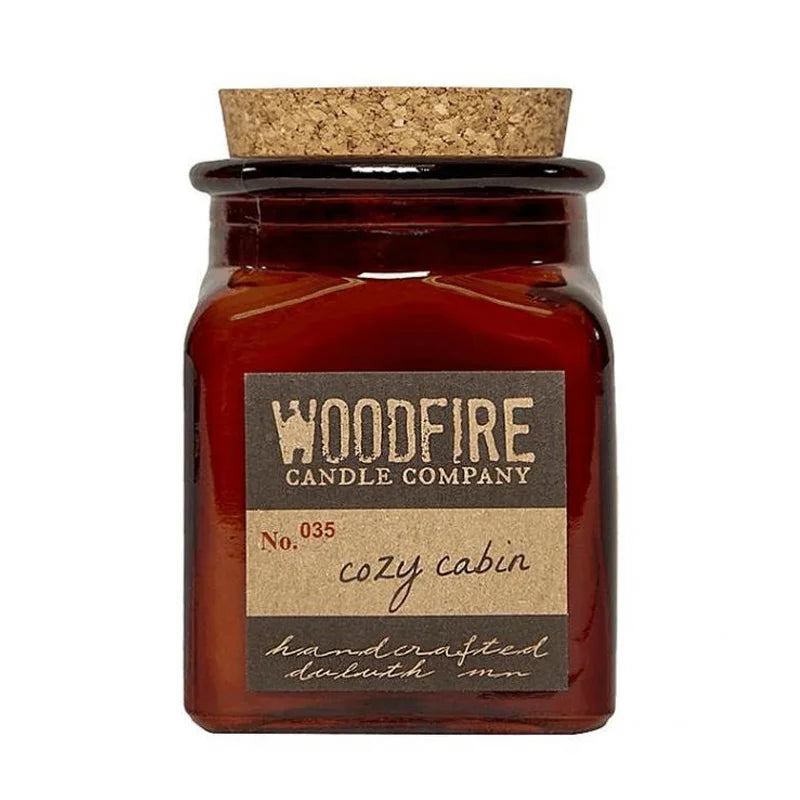 Woodfire Candle Company Soy Candle in cozy cabin with a white background