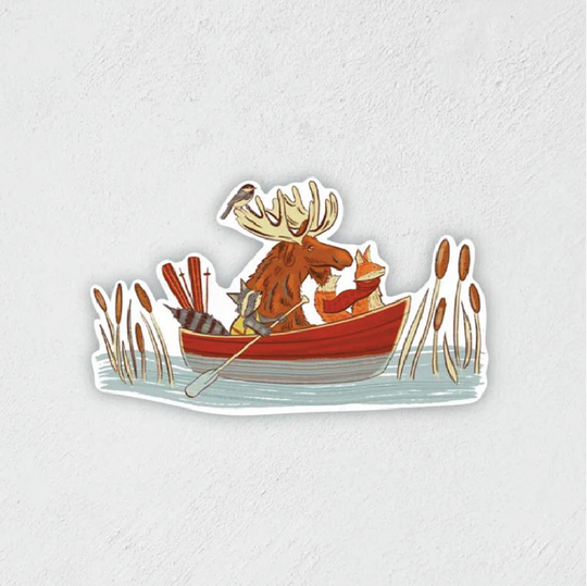 Sticker of a moose, raccoon, and fox riding in a canoe