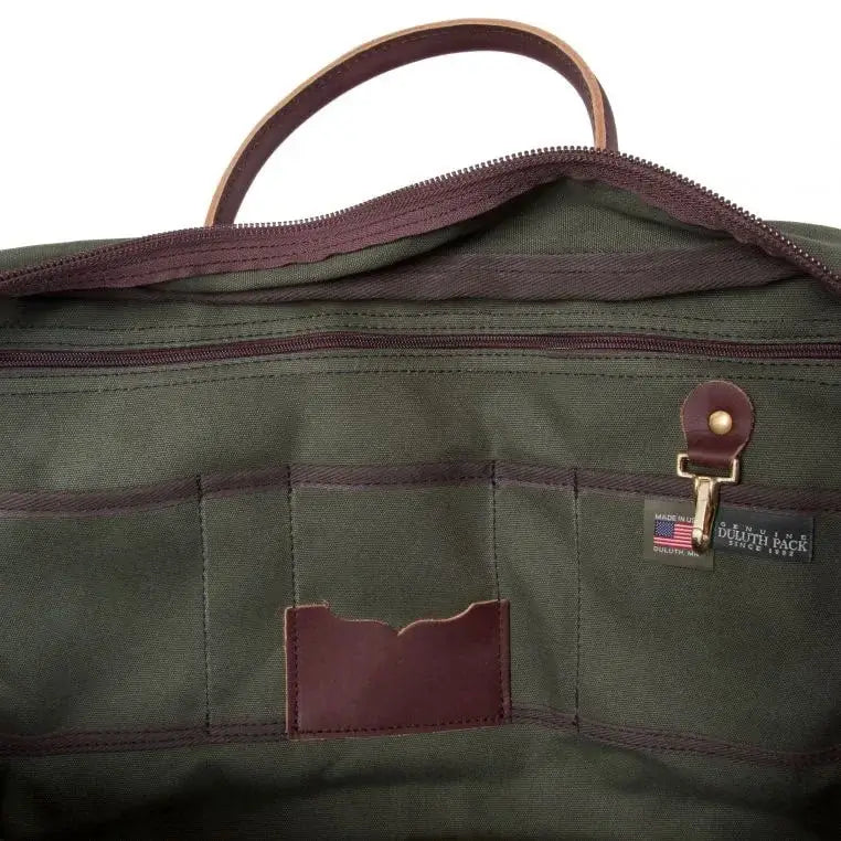The Inside Of The Freelance Briefcase In Olive Drab Green As Seen From The Side On A White Background Showing The Many Slip Pockets, Zipper Pockets, Key Clip, Tags