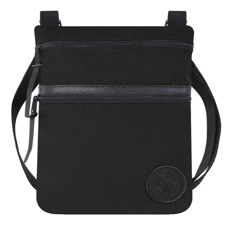 Traverse Crossbody Bag in black featuring durable canvas construction, two zippered compartments, and an adjustable cotton webbing strap, designed for rugged outdoor use.