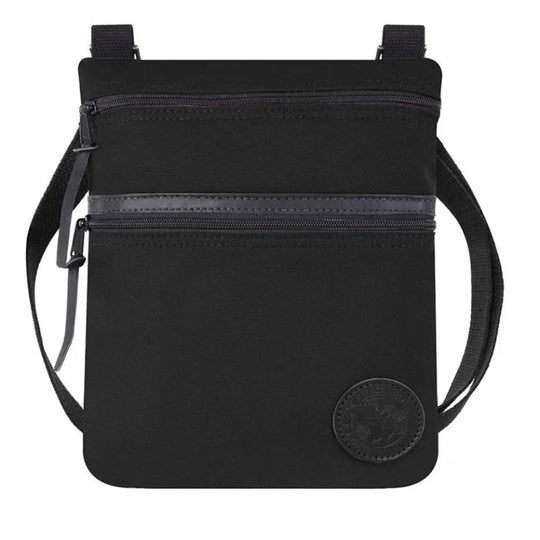 Traverse Crossbody Bag in black featuring durable canvas construction, two zippered compartments, and an adjustable cotton webbing strap, designed for rugged outdoor use.