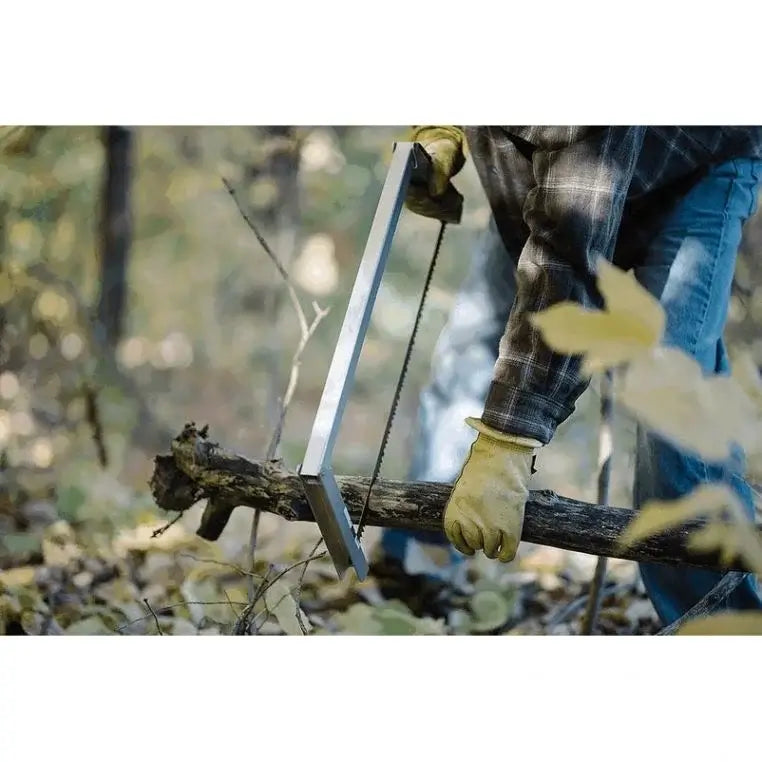 Spring Creek Tuff Camp Saw Being Used To Saw A Medium Sized Tree Limb