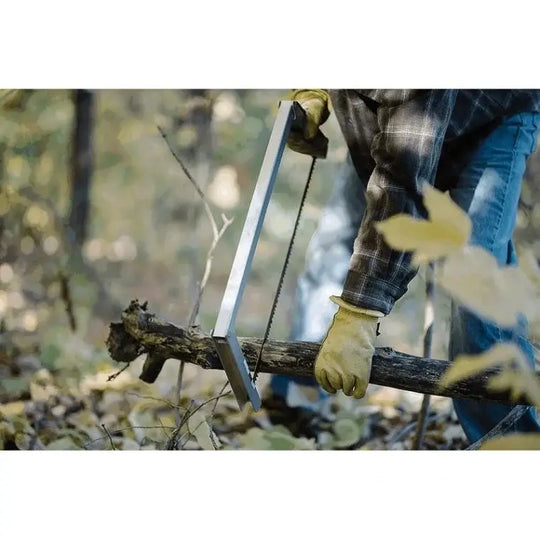Spring Creek Tuff Camp Saw Being Used To Saw A Medium Sized Tree Limb