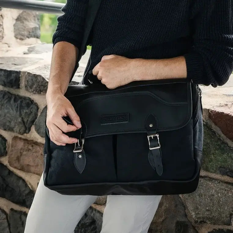 Superior Series Leather Entrepreneur Briefcase Being Carried By A Man Leaning On A Stone Wall
